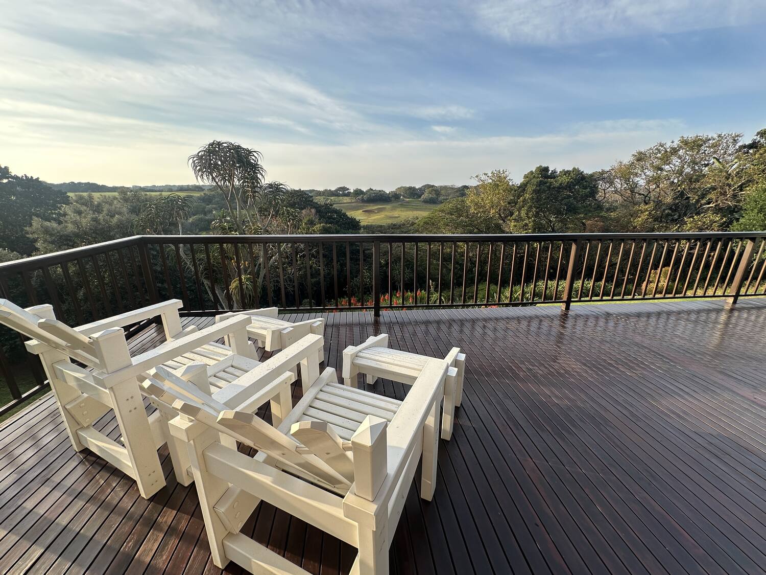 Deck chairs with golf course and sky views