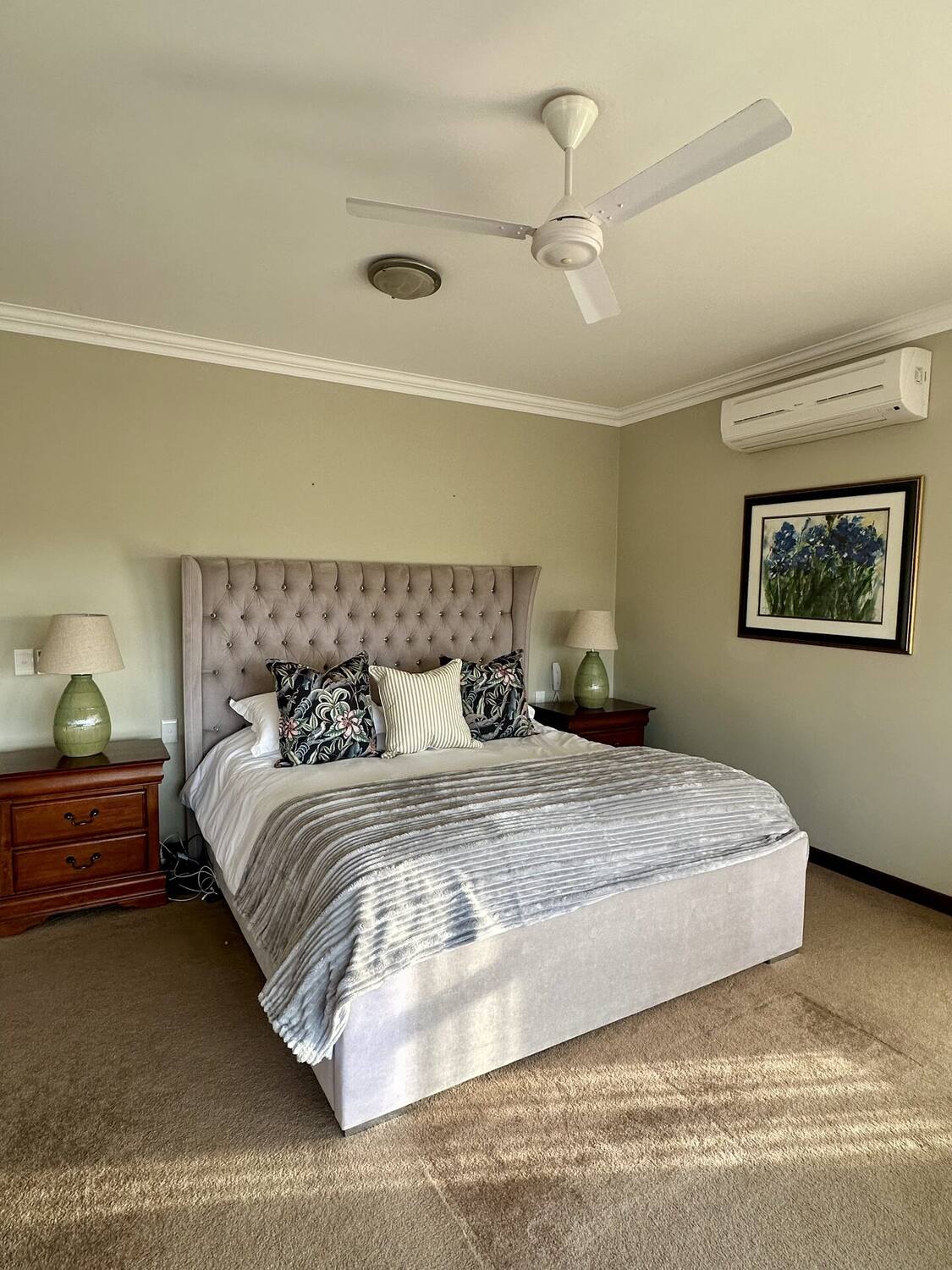 Master bedroom — second view with armchair and en-suite access