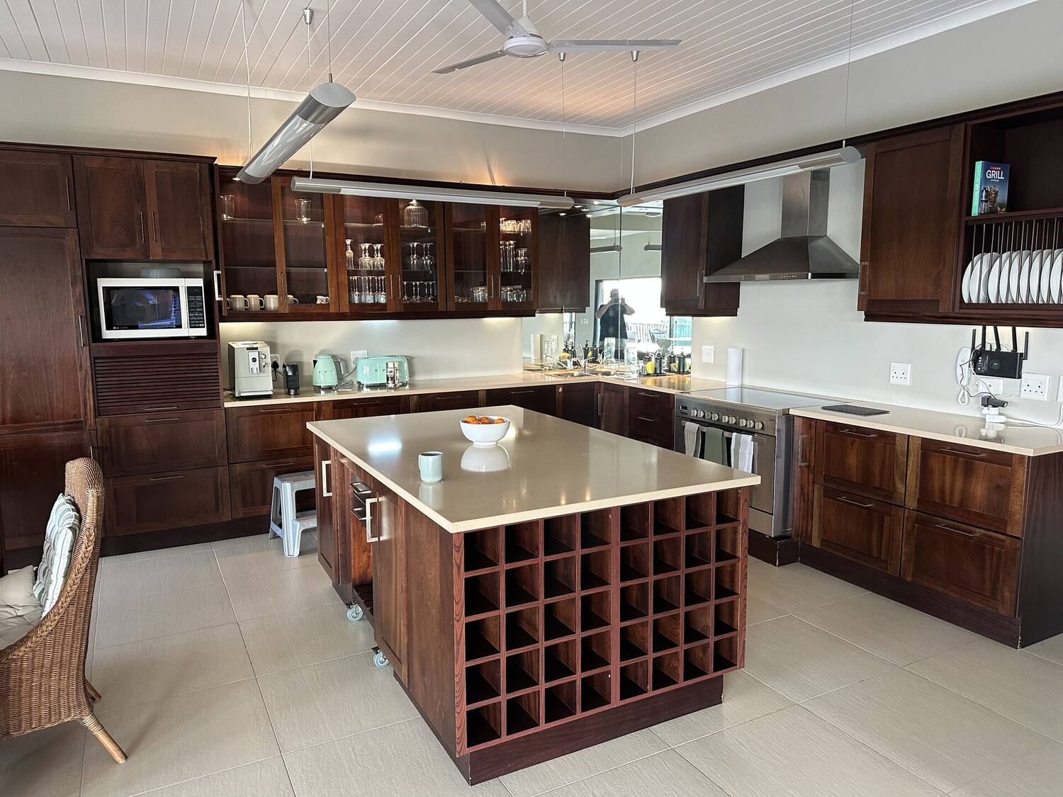 Kitchen — dark wood cabinetry and island with wine storage